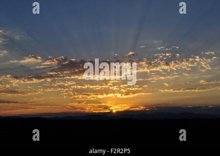 Sunset with Crepuscular Rays on the Olympic Mountains photographed near Shelton, WA, USA. Stock Photo