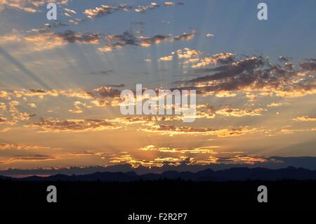 Sunset with Crepuscular Rays on the Olympic Mountains photographed near Shelton, WA, USA. Stock Photo