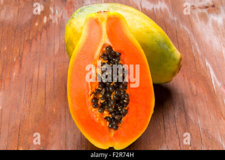 top view sliced fresh papaya on old wooden table Stock Photo