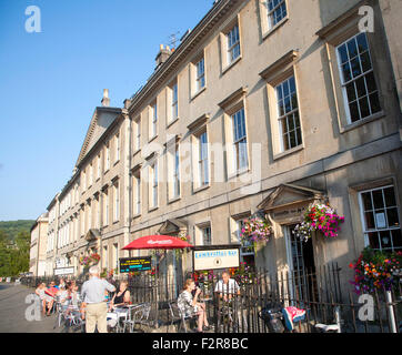People sitting outside cafes on Georgian buildings street of North Parade, Bath, Somerset, England, UK Stock Photo