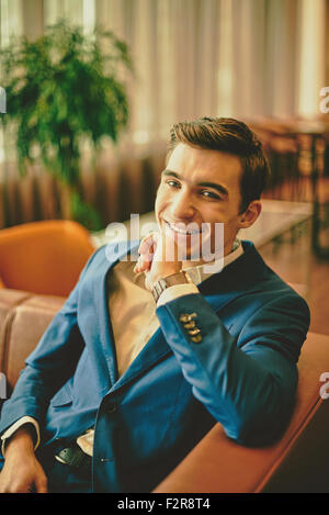 Happy young businessman looking at camera Stock Photo