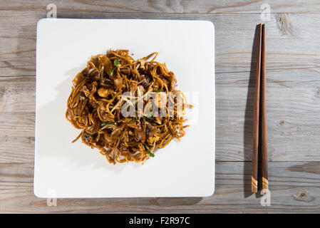 Fried Penang Char Kuey Teow top down view which is a popular noodle dish in Malaysia, Indonesia, Brunei and Singapore Stock Photo