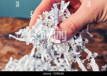 Hand is holding a bunch of shredded paper Stock Photo