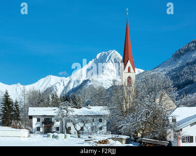 Haselgehr village and Catholic parish church St. Martin. Winter view (Austria, Tirol). 1689 a chapel was named in Martin Unterho Stock Photo