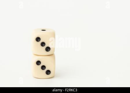 Two stacked dice showing the lucky number three. With copy space Stock Photo