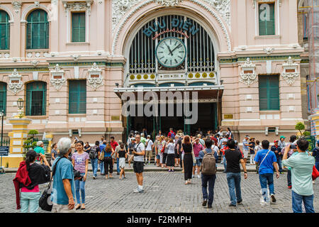 Customers and visitors to the post office. It was built during 1886 -1891 and It is the largest post office in Vietnam. Stock Photo