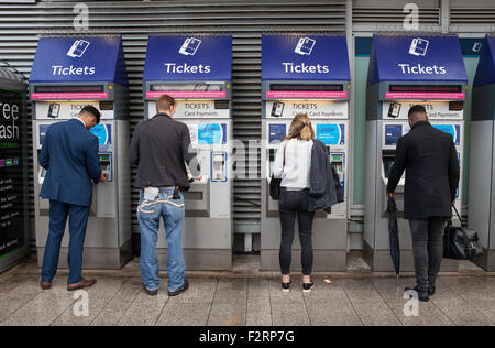 Rail passengers use self-service ticket machines at London Bridge train station Stock Photo