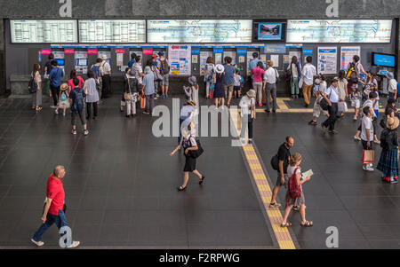 Passengers buy tickets from self service ticket machines at Kyoto station Stock Photo