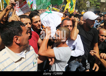 Mourners carry the body of 18-year-old Palestinian Hadeel al-hashlamon, who was shot and killed by Israeli soldiers in the West Bank city of Hebron. In less than 24 hours, the Israeli army shot and killed two Palestinians. On September 22, 2015, the Israeli army claimed that 21-year-old Diyaa Abdul-Halim Talahmah was killed when a hand-made grenade exploded in his hands during clashes with Israeli forces in the village of Khursa, south of Hebron. However, there were contradictory reports from both Palestinian and Israeli sources and photos of the youth's body showed that he had been shot. That Stock Photo