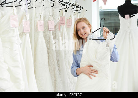 Bride Choosing Dress In Bridal Boutique Stock Photo