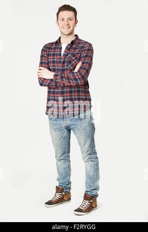 Portrait Of Man Standing In Studio On White Background Stock Photo