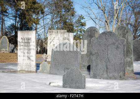 Old headstones at Forest Hill Cemetery in East Derry, New Hampshire USA during the winter months. Stock Photo