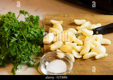 Ready to chop garlic and parsley as a condiment to make a meal Stock Photo