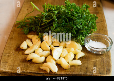 Ready to chop garlic and parsley as a condiment to make a meal Stock Photo