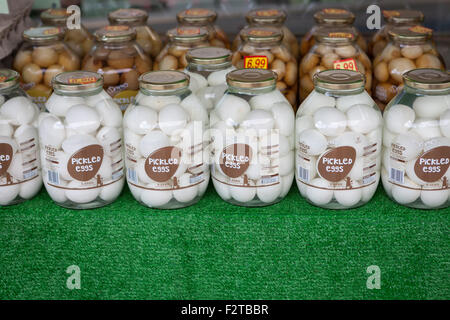 Jars of pickled eggs for sale outside a shop Stock Photo