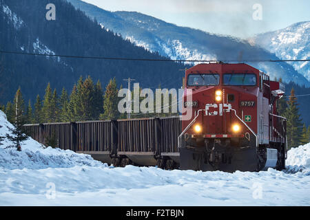 Canadian Pacific train coming round the bend with Canadian Rockies in the background in winter Stock Photo