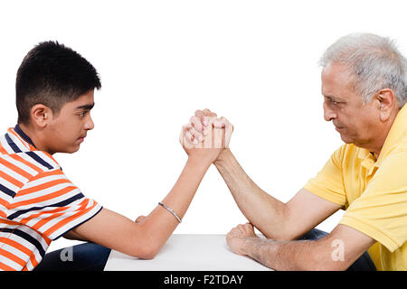 2 indian Grandfather and  Grandson Arm Wrestling Stock Photo