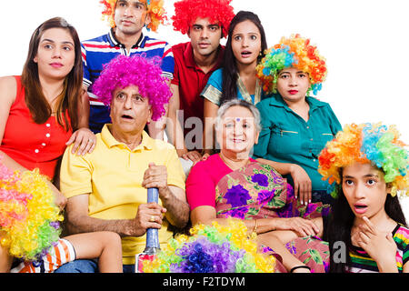 indian group Joint Family sitting sofa Television watching Cricket Stock Photo