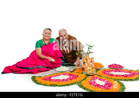 2 indian Senior Married Couple diwali Festival Rangoli Stock Photo