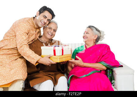 3 indian Parents and son diwali Festival gift Giving Stock Photo