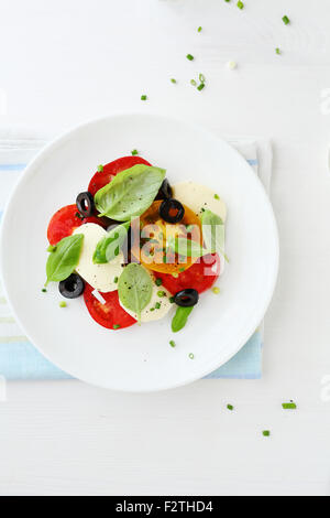 Salad with tomatoes and cheese, top view Stock Photo