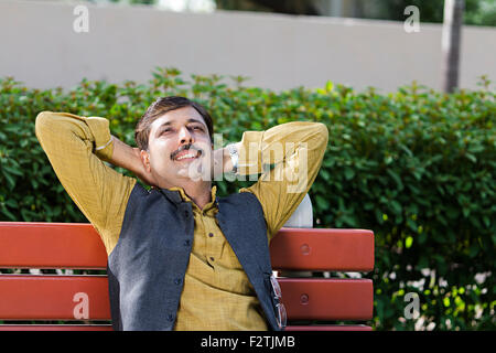 1 indian Adult Man park sitting bench Relaxation Thinking Stock Photo