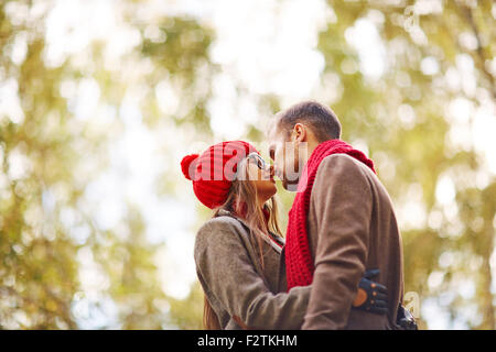 Amorous couple embracing in park Stock Photo