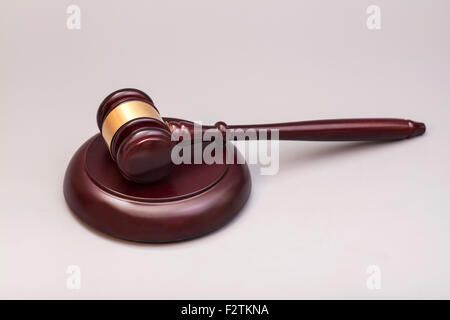 wooden judge gavel and soundboard on grey background Stock Photo