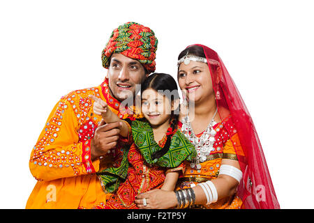 3 indian Rajasthani Villager Parents and daughter finger pointing showing Stock Photo