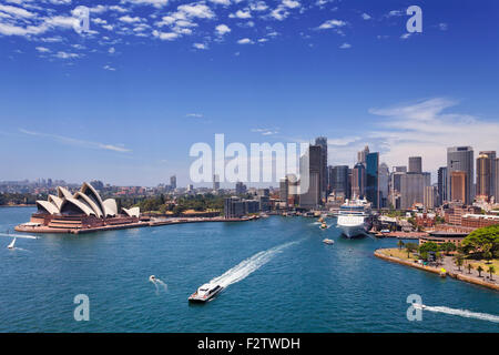 Sydney city landmarks in Australia on a bright summer sunny day from Harbour bridge looking out on ferries and ships around CBD Stock Photo