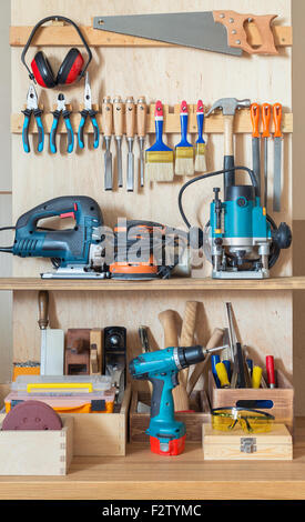 Workshop tool board with various hand tools for repairing and woodworking. Stock Photo