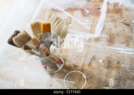 Paint brushes on the workshop table. Stock Photo