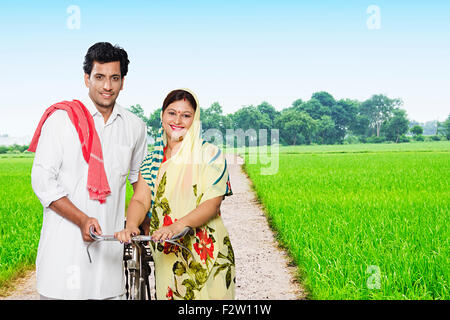 2 indian Married Couple Rural Farmer farm Riding Bicycle Stock Photo