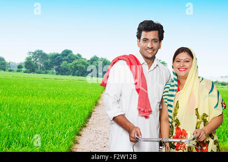 2 indian Married Couple Rural Farmer farm Riding Bicycle Stock Photo