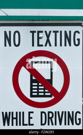 NO TEXTING WHILE DRIVING sign dangerous practice Stock Photo