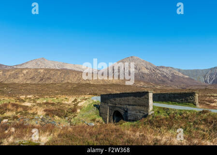 Bridge on the Isle of Skye with road and mountains in Scotland. Stock Photo