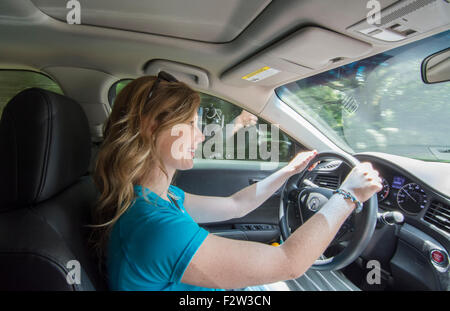 Young teenage girl age 16 with Dad in passenger seat as she drives car for the first time MR model released Stock Photo
