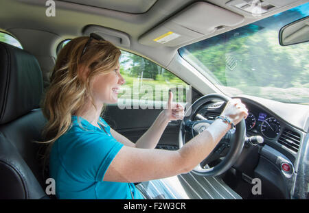 Young teenage girl age 16 with Dad in passenger seat as she drives car for the first time MR model released Stock Photo