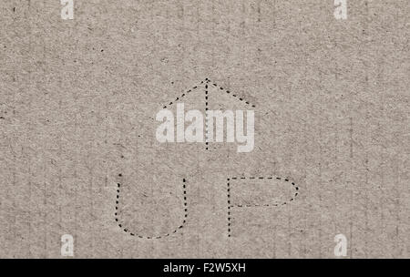 "up" with arrow on cardboard Stock Photo