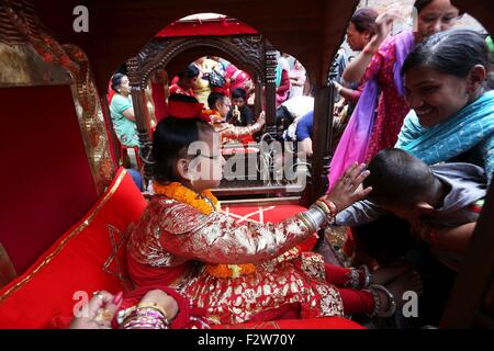 Kathmandu, Nepal. 24th Sep, 2015. Nepal's 'living god' as the reincarnation of Lord Ganesh (L) offers blessings to a devotee on Indrajatra festival in Kathmandu, Nepal, Sept. 24, 2015. © Sunil Sharma/Xinhua/Alamy Live News Stock Photo