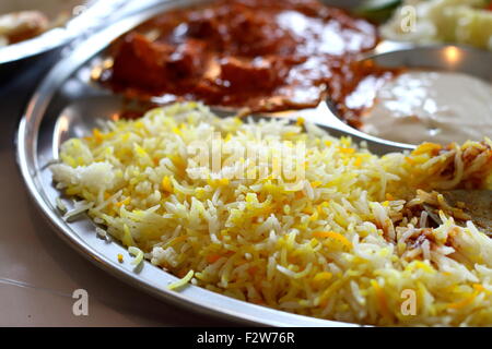 Close up shot of Saffron rice and butter chicken in a tray Stock Photo