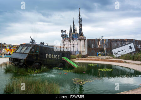 The 'waterpark' at Banksy's Dismaland with riot van in the water with a slide Stock Photo