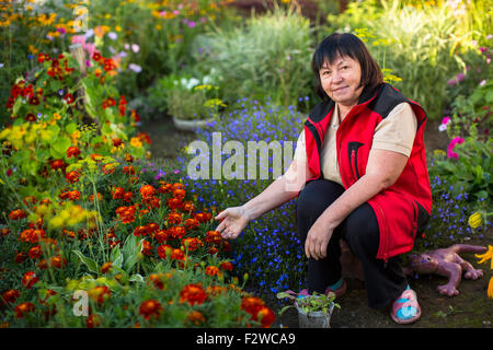 Mature woman in her garden. Stock Photo