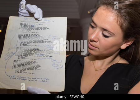 London, UK. September 24th, 2015. A member of Sotheby's staff displays Bob Dylan's never seen before draft of 'It's A Hard |Rain's Gonna Fall', described by Rolling Stone magazine as the gretatest protest song by the greatest protest songwriter of his time. Expected to fetch up to £200,000 at auction, it features in in the Sotheby's Rock and Pop exhibition, running 24th - 28th September ahead of an auction on the 29th. Credit:  Paul Davey/Alamy Live News Stock Photo