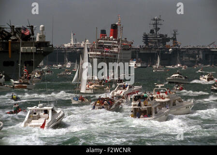 AJAXNETPHOTO. JUNE,1994. SPITHEAD, ENGLAND. - D-DAY ANNIVERSARY ROYAL FLEET REVEW - SPECTATOR FLEET OF SMALL BOATS CHURN UP THE SEA AS THEY FOLLOW HMRY BRITANNIA DOWN THE LINES OF MOORED SHIPS. PHOTO:JONATHAN EASTLAND/AJAX REF:1708 70 Stock Photo