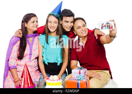 4 indian Presents young daughter and son Birthday Celebration Mobile Phone picture Clicking Stock Photo