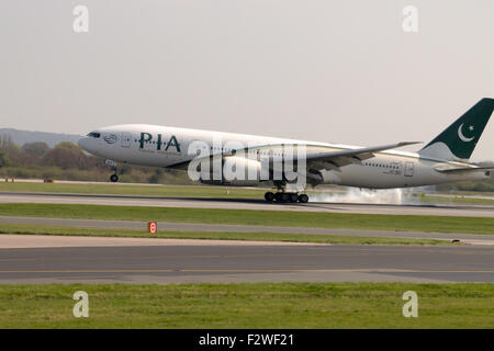 Pakistan International Airways Boeing 777-240LR (AP-BGY) landing to Manchester International Airport runway. Stock Photo