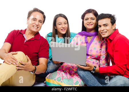 4 indian family Parents young daughter and son laptop Chatting Stock Photo