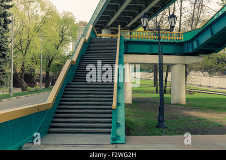 Footsteps of Alexander bridge in the park named after Gorky. Split toning. Stock Photo