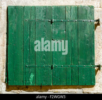 old window with  closed green wooden shutters Stock Photo